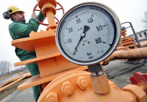 Local workers control a gas valve at the