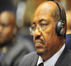 Omar Hassan Ahmad al-Bashir, president of Sudan, listens to translated remarks during the opening of the 20th session of The New Partership for Africa's Development (NEPAD)