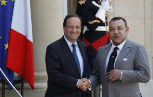 France's President Hollande greets Morocco's King Mohammed VI before talks at the Elysee Palace in Paris